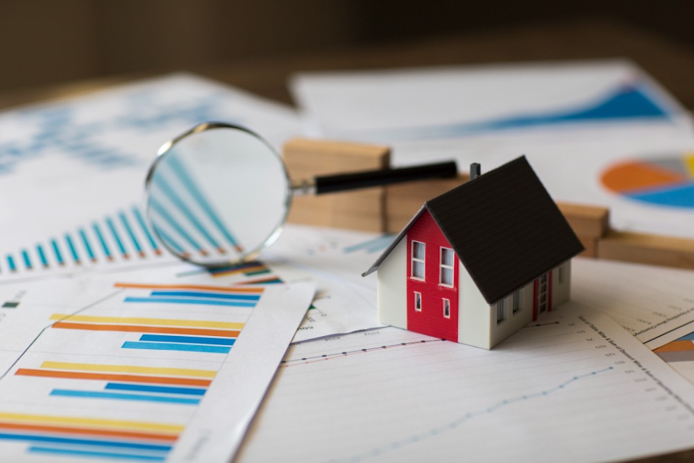 Minature House on a Financial Graph